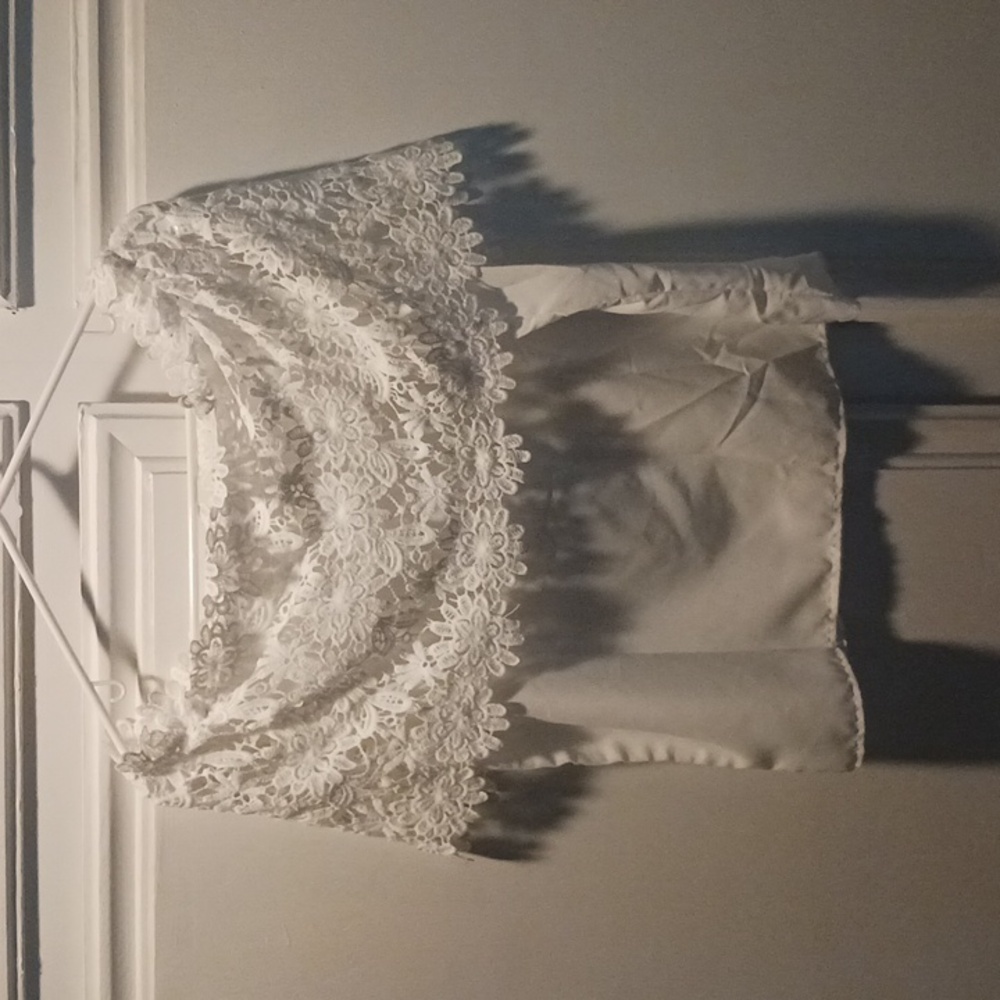 Womens lace topNWoT. All white . Photo has shade  on it.